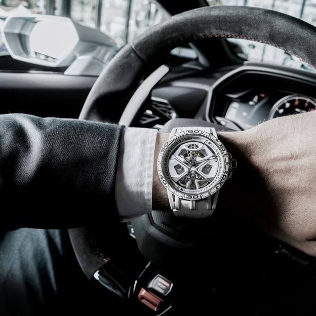 Roger Dubuis watch worn by a man in a lamborghini car