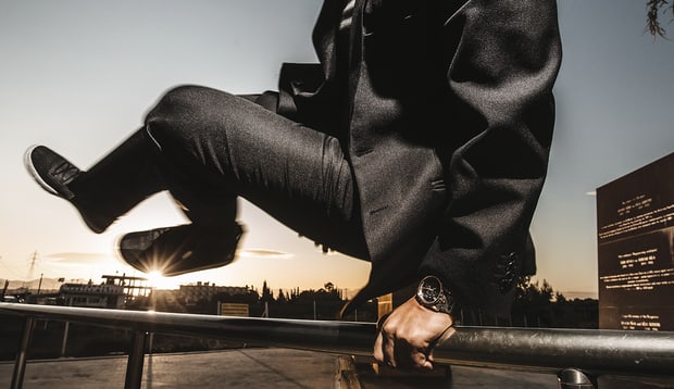 Roger dubuis watch, man jumping over a fence